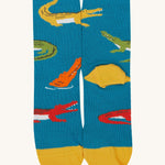 A close up of the Frugi teal multicoloured crocodile sock a soft GOTS cotton sock features a yellow sole and toes panel