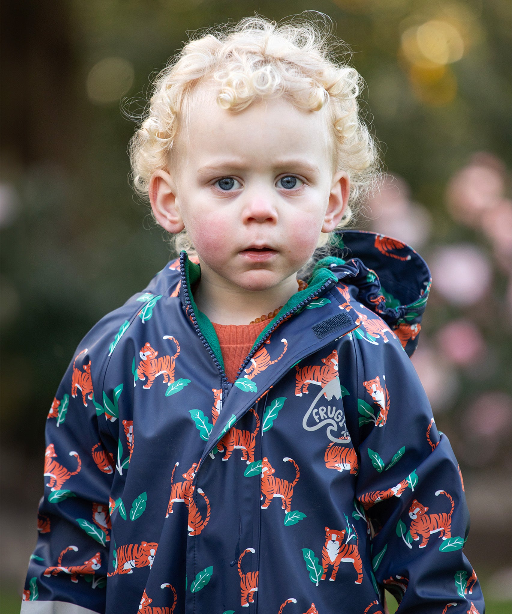  wearing the Frugi Children's Puddle Buster All In One - Tiger Time