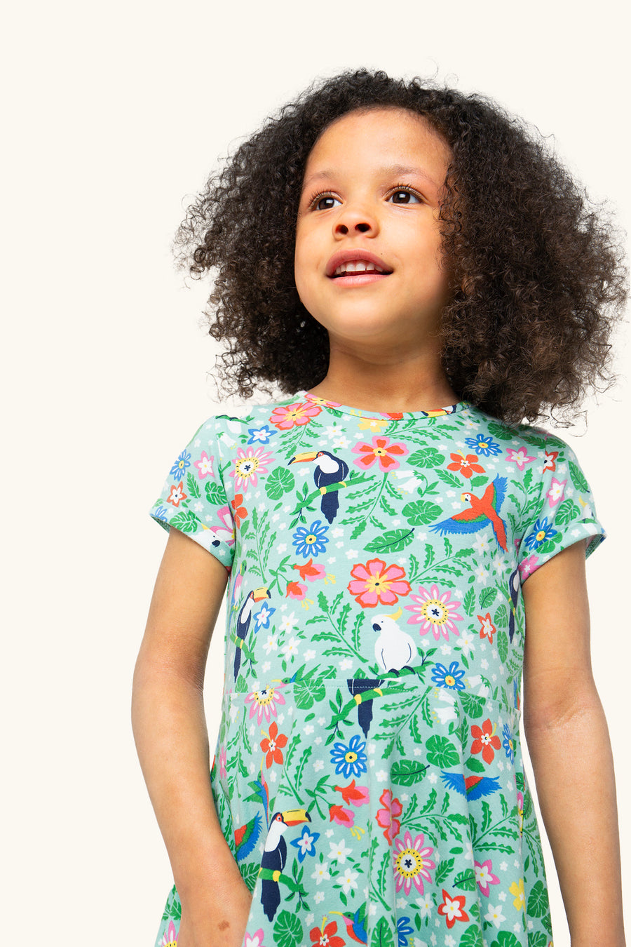 A closer look at the Tropical print on the Frugi Children's Organic Cotton Spring Skater Dress - Tropical Birds. A beautiful tropical bird and flower print on a twirly short sleeve skater dress