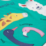 A close up of the Frugi kids long neck pals t-shirt. Showing the different long necked animals appliqué including a giraffe and emu, flamingo and llama with animal names on green organic cotton fabric