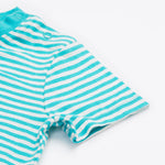 A close up of the Frugi kids moss stripe wildlife t-shirt. Showing the shoulder popper fasteners for easy fitting, light blue neck trim and short sleeves on blue and white stripe organic cotton fabric