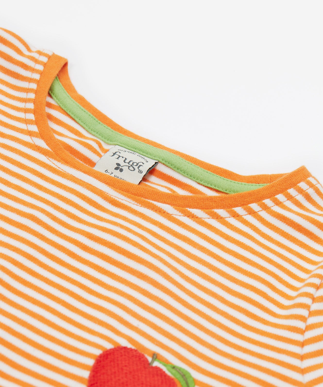 Close up of the Frugi kids lifeboat stripe veg t-shirt. Showing the solid orange neck detail  orange and white stripe organic cotton fabric