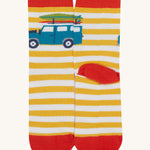 A close up of the Frugi campveran yellow and white sock a soft GOTS cotton sock features a red sole and toes panel