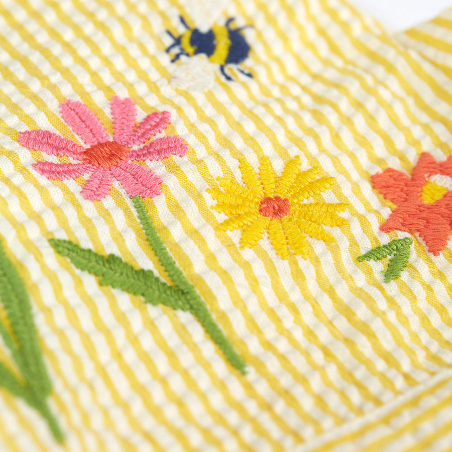 The back of the the Frugi Jasmine Dress - Flowers made from GOTS Organic cotton. A light sunshine