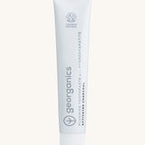 Front view of the Georganics activated charcoal hydroxyapatite toothpaste. A white tube with grey and black branding text. 