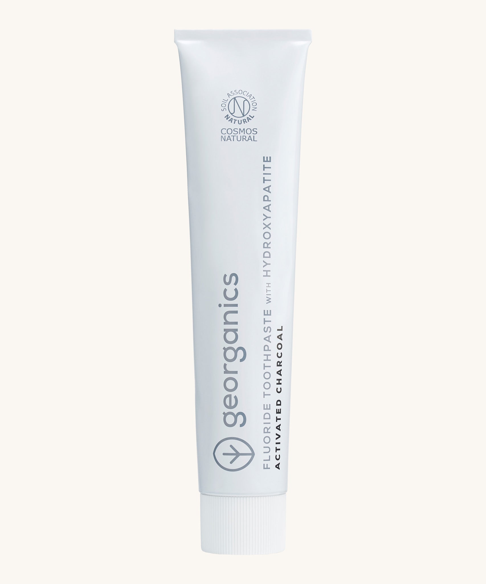 Front view of the Georganics activated charcoal hydroxyapatite toothpaste. A white tube with grey and black branding text. 