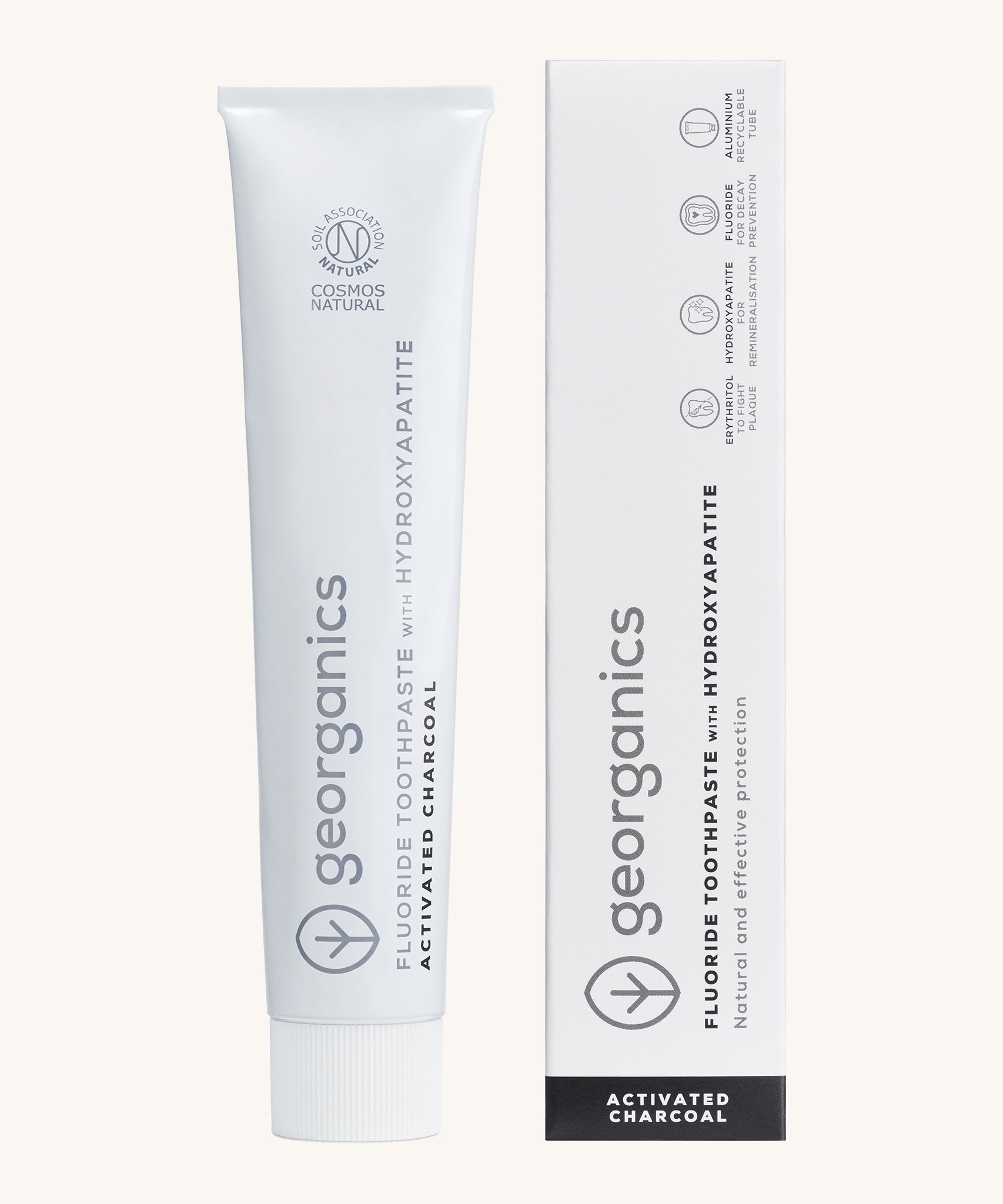 Front view of the Georganics activated charcoal hydroxyapatite toothpaste. A white tube with grey and black branding text next to matching cardboard packaging. 