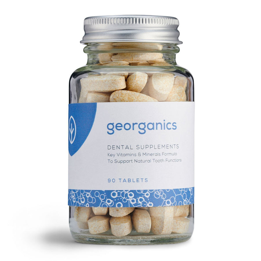 Jar of Georganics dental vitamin and mineral supplement tablets in a glass jar on a white background