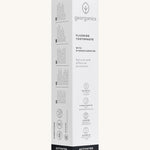 Side view of the Georganics activated charcoal hydroxyapatite toothpaste cardboard packaging, white with grey and black  text showing the instructions and features.