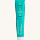 Back view of the Georganics fresh mint hydroxyapatite toothpaste tube. Showing the ingredients and features in white text.