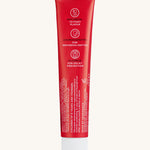 Back view of the Georganics strawberry hydroxyapatite toothpaste tube. Showing the ingredients and features in white text