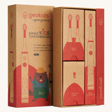 Close up view of the Georganics sonic kids toothbrush set cardboard packaging. Features different compartments for each piece. Features a playful beaver design on the front lid