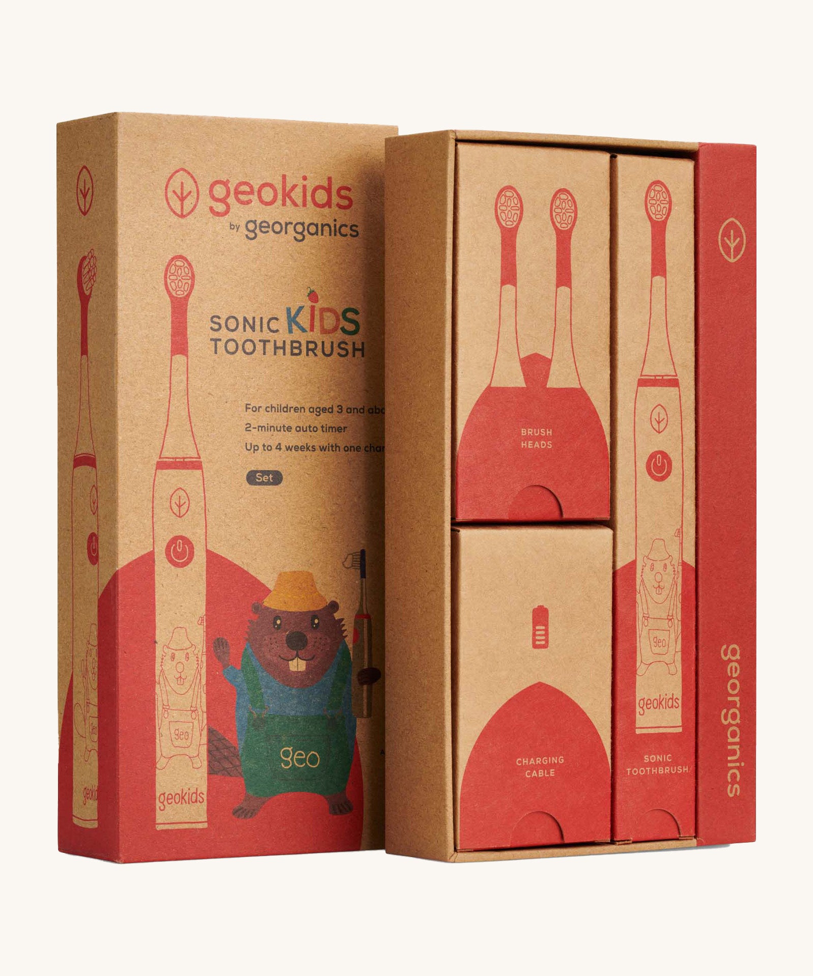 Close up view of the Georganics sonic kids toothbrush set cardboard packaging. Features different compartments for each piece. Features a playful beaver design on the front lid