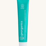 Front view of the Georganics fresh mint hydroxyapatite toothpaste. A light green tube with white and blue branding text. 