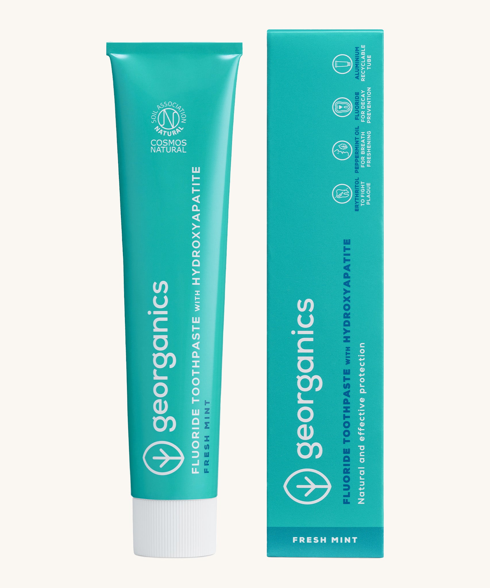 Front view of the Georganics fresh mint hydroxyapatite toothpaste. A light green tube with white and blue branding text next to matching cardboard packaging. 