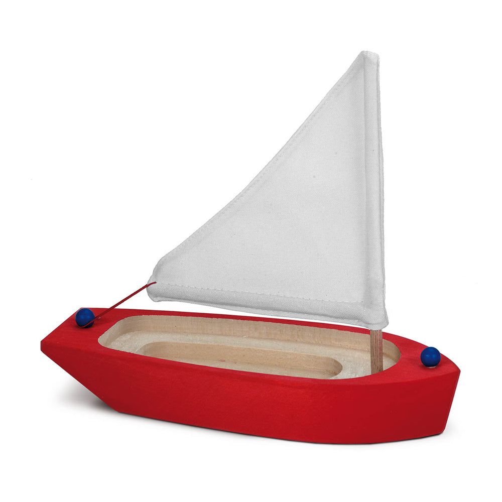 Gluckskafer childrens small wooden sailing ship toy in red on a white background