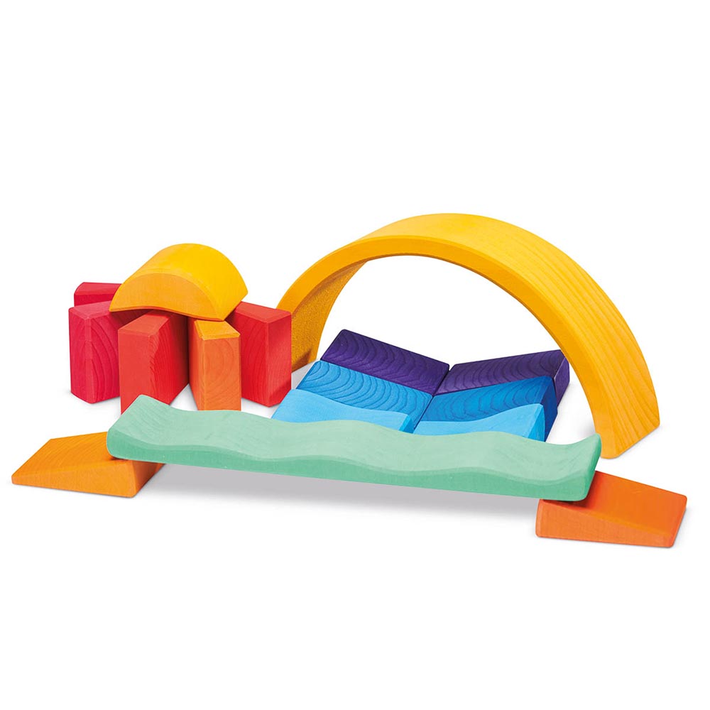 Pieces of the Gluckskafer childrens wooden sunray block set laid out on a white background