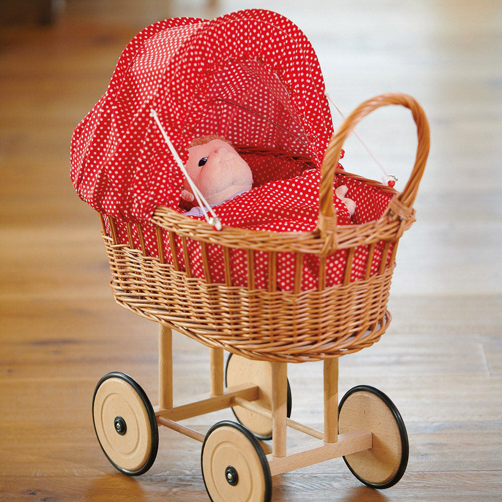 wicker basket pram pictured with a doll inside