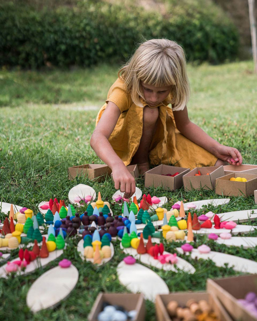 Close up of a girl playing with the Grapat handmade mandala toy pieces on the large petal blocks