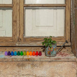 Grapat Mandala Rainbow Eggs lined up on a window sill.