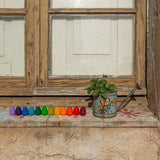 Grapat Mandala Rainbow Eggs lined up on a window sill.