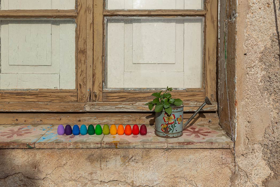 Grapat Mandala Rainbow Eggs lined up on a window sill.