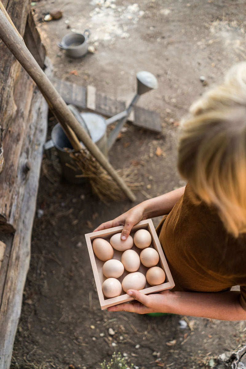 Close up of child holding the Grapat eco-friendly square wooden toy box