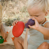 Children have filled the Grapat Wooden Rainbow Sorting Pots with sand and various items found on the beach