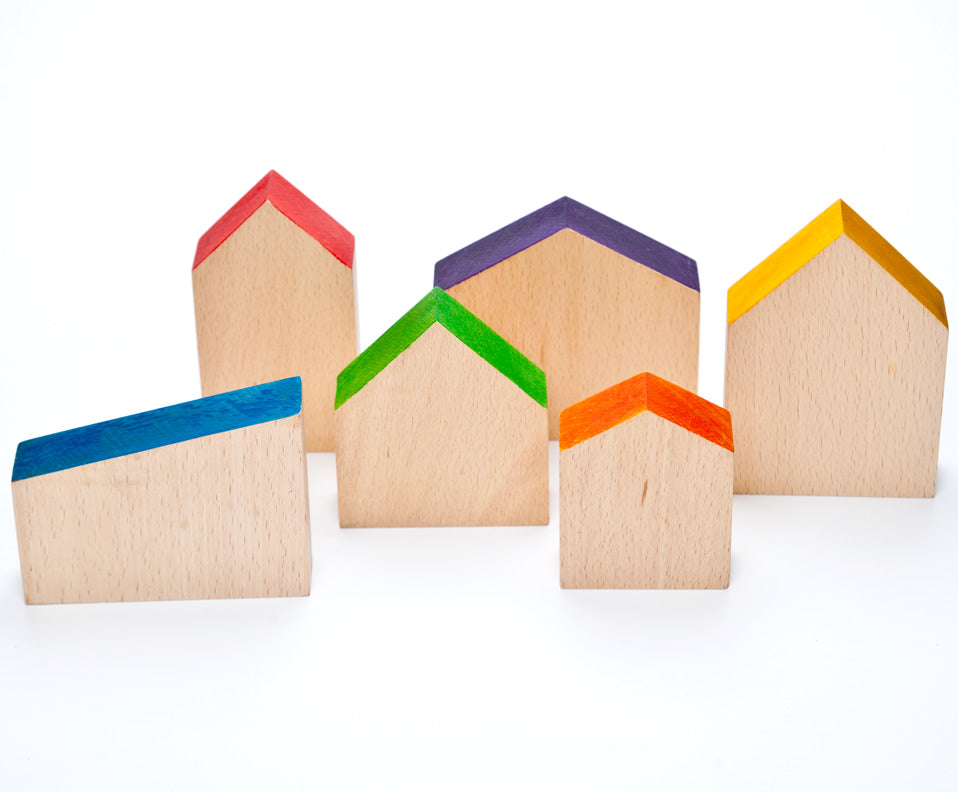 Grapat Six Wooden Houses Set in different simple geometric shapes in natural wood and colourful painted roofs. White background.