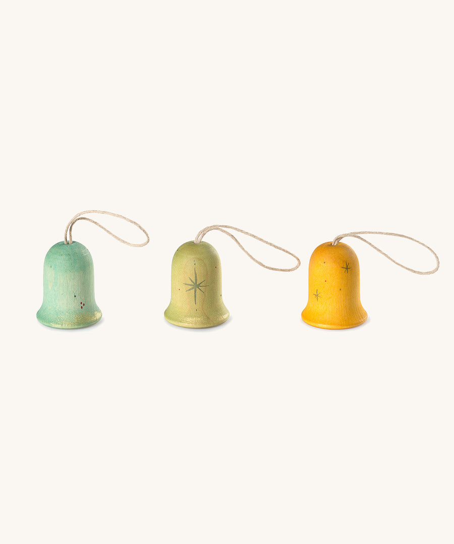 A light blue, green and yellow Grapat wooden Grapat jingle joy bells on a cream background.