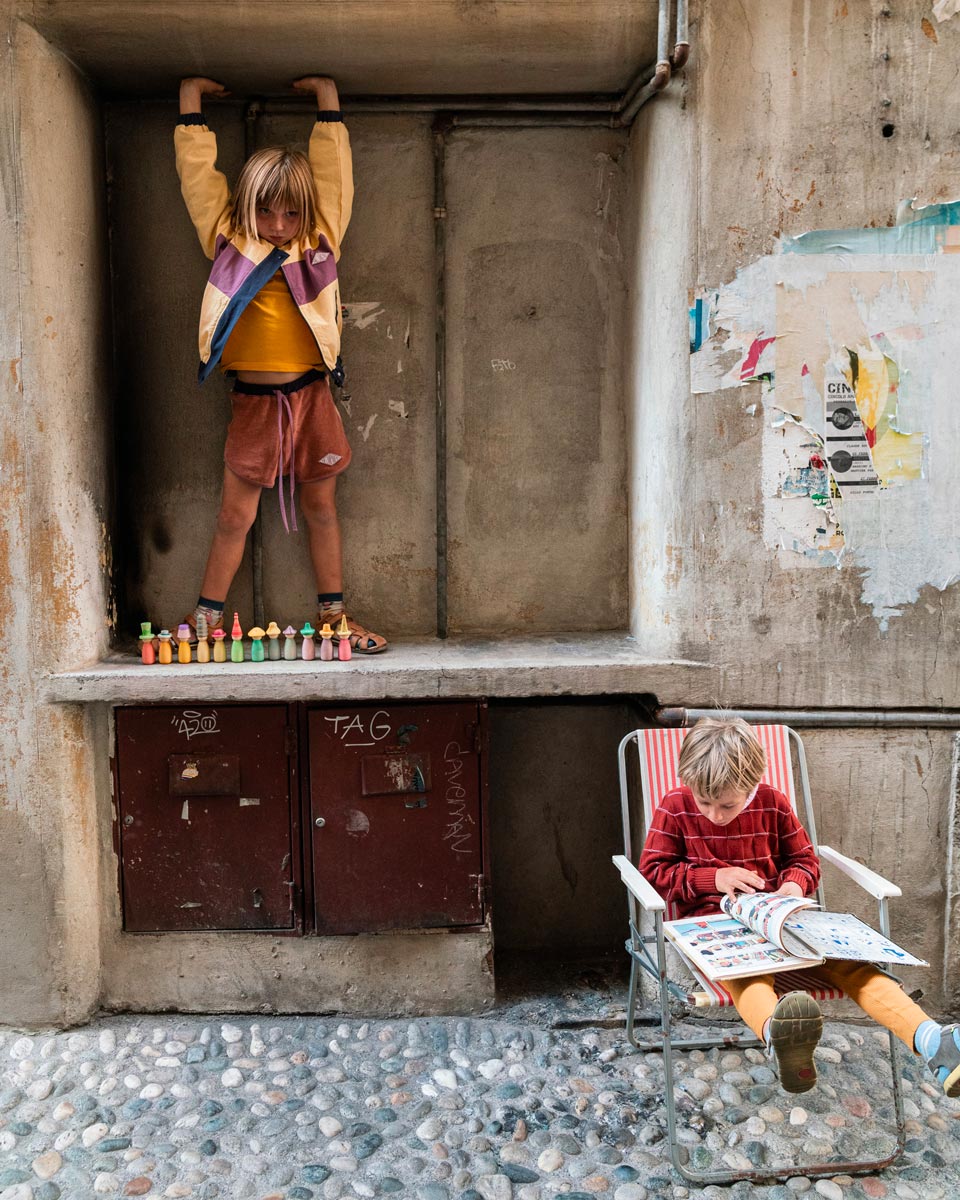 Girl stood on a concrete shelf next to some Grapat Fancy Nin waldorf figures