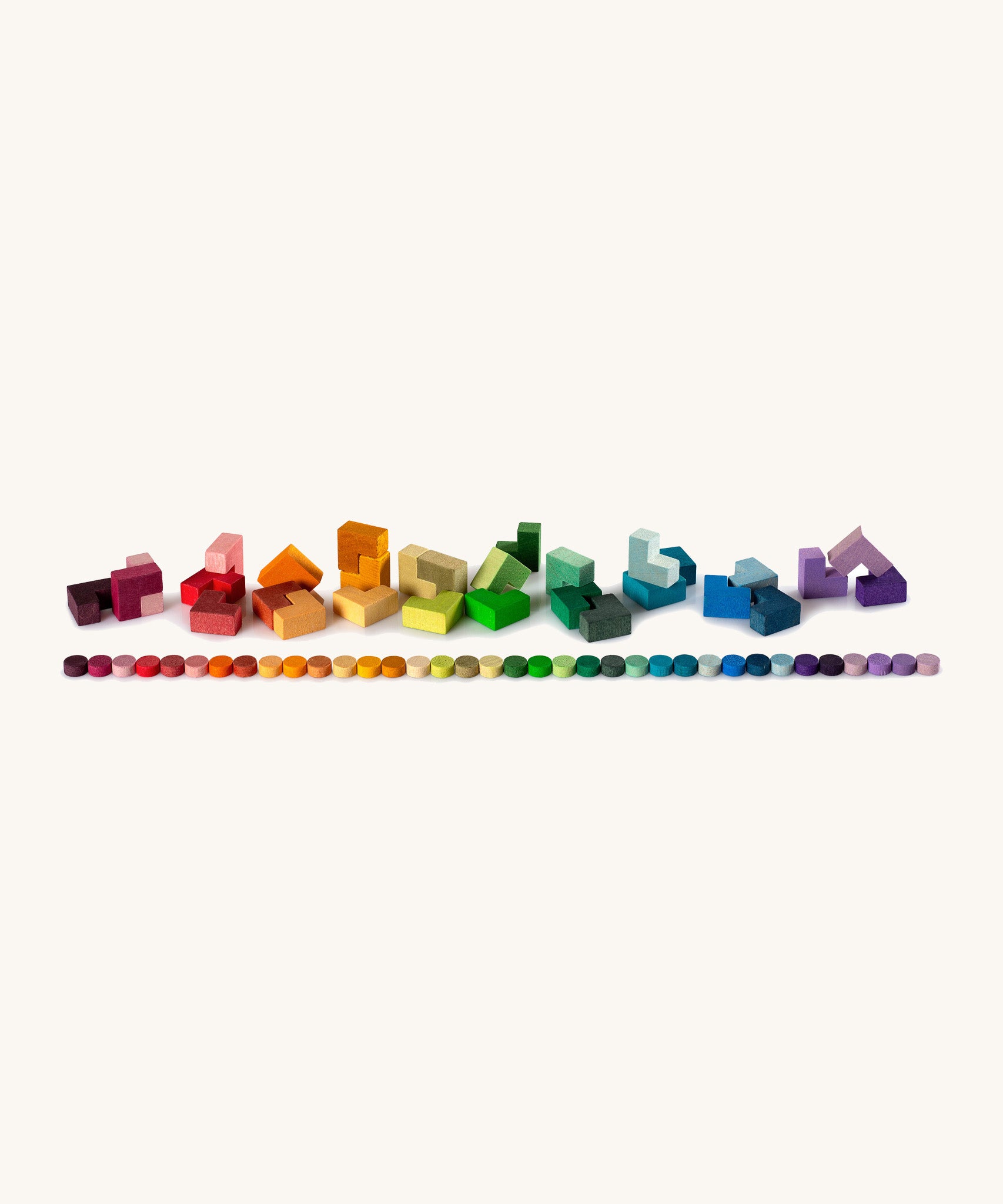 Grapat Mis Match & Bloom – a vibrant loose parts play set with an array of wooden shapes, circles and tetris-like pieces in a rich rainbow gradient. 
