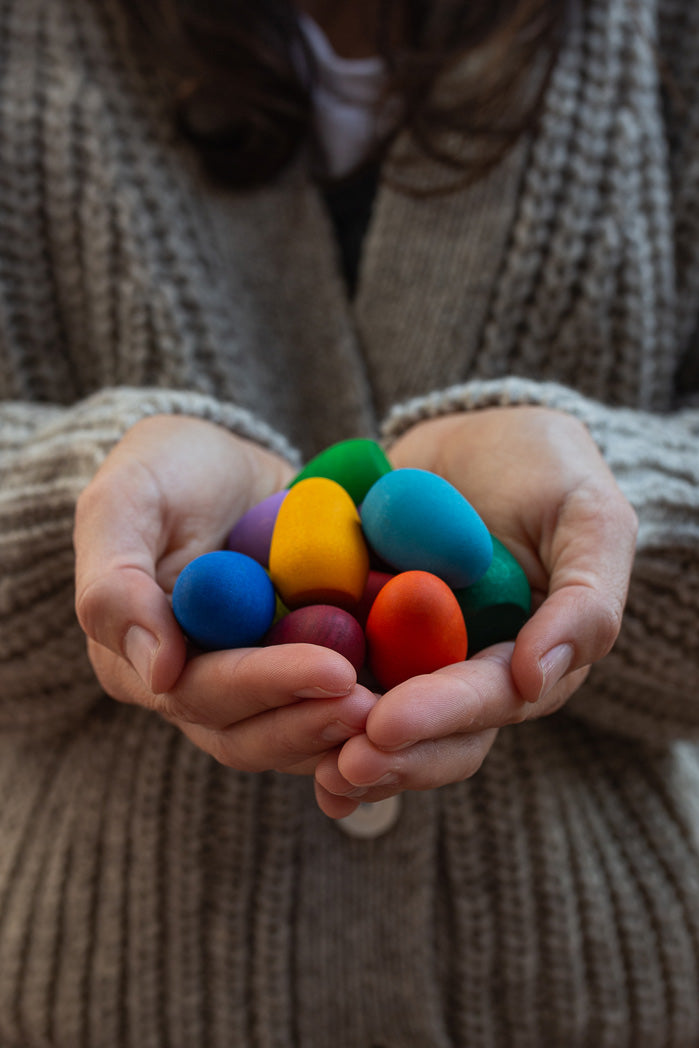 Grapat rainbow eggs held in hand.