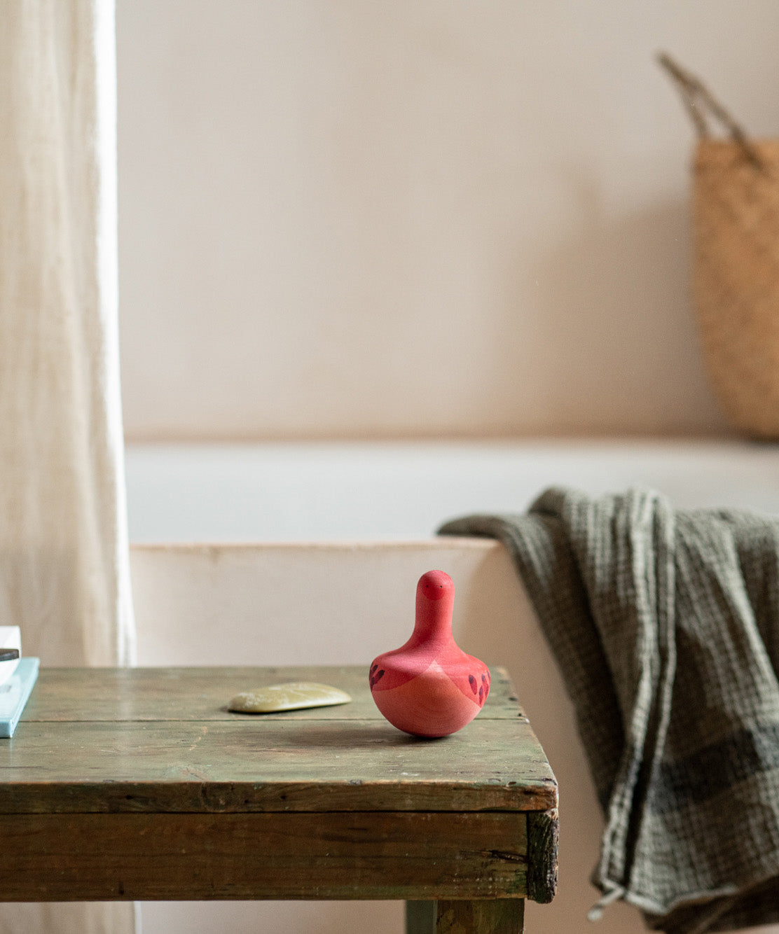 A Grapat wooden pink chill bird on a wooden table