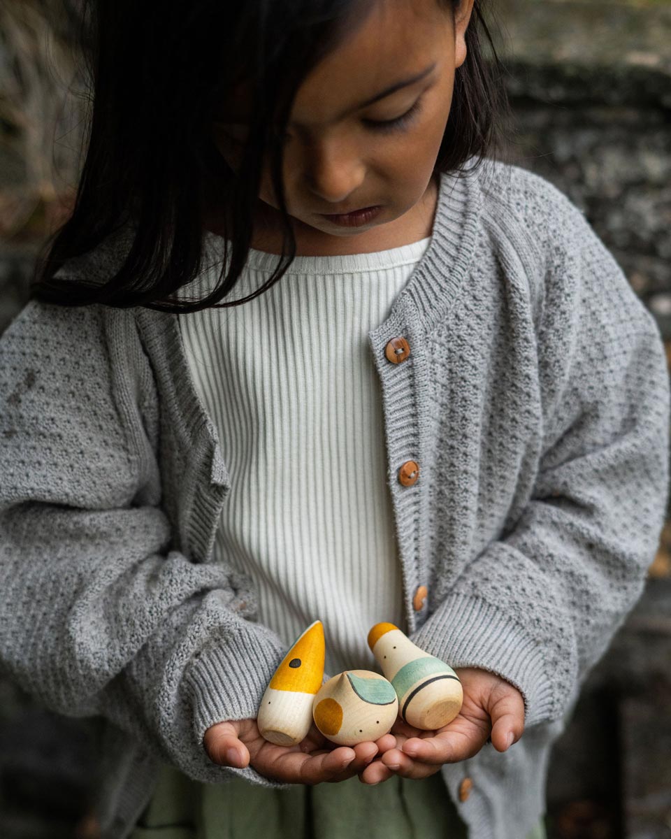 Close up of a child holding the Grapat wooden hooray toy figures