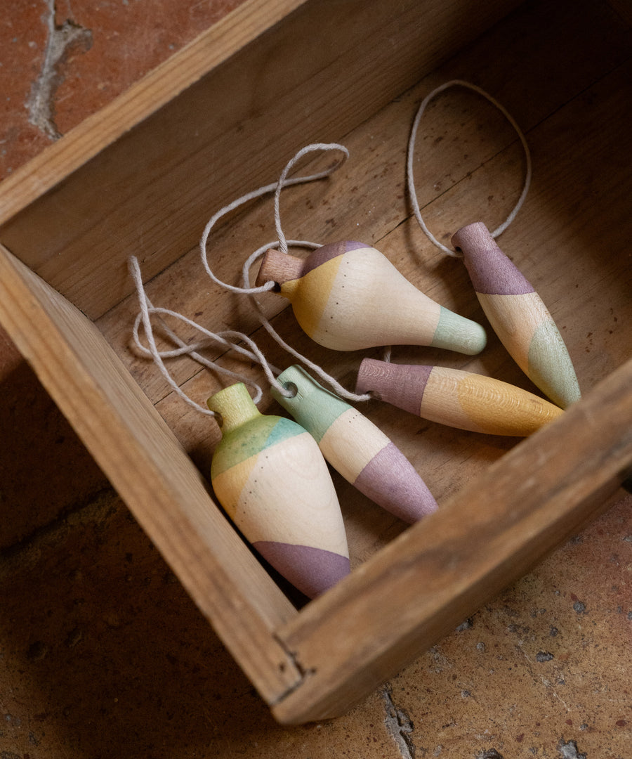 Multicoloured wooden Grapat twinkle decorations in a wooden box