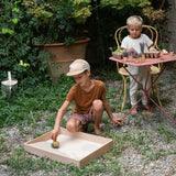 A child playing with the Grapat wooden yellow flowing bird outside 