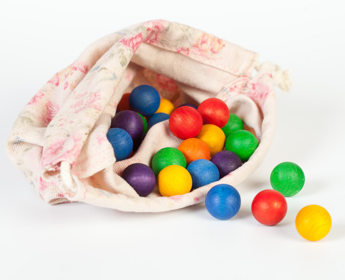 Grapat 36 Wooden Marbles, in six rainbow colours in a fabric storage bag. White background.