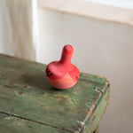 A Grapat wooden pink chill bird on a wooden table