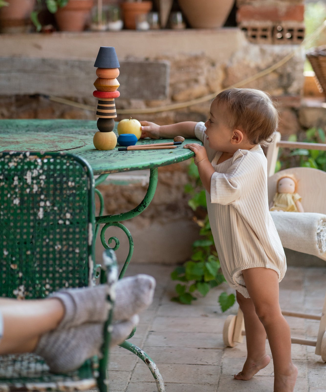 A child playing with the Grapat serendipity wooden stacking set on a table