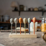 Grapat wooden twin soul puppets on a wooden stand on a table