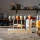 Grapat wooden twin soul puppets on a wooden stand on a table