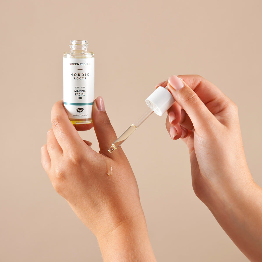 Person using the pipette to apply some Green People Nordic Roots Marine Facial Oil to their hand