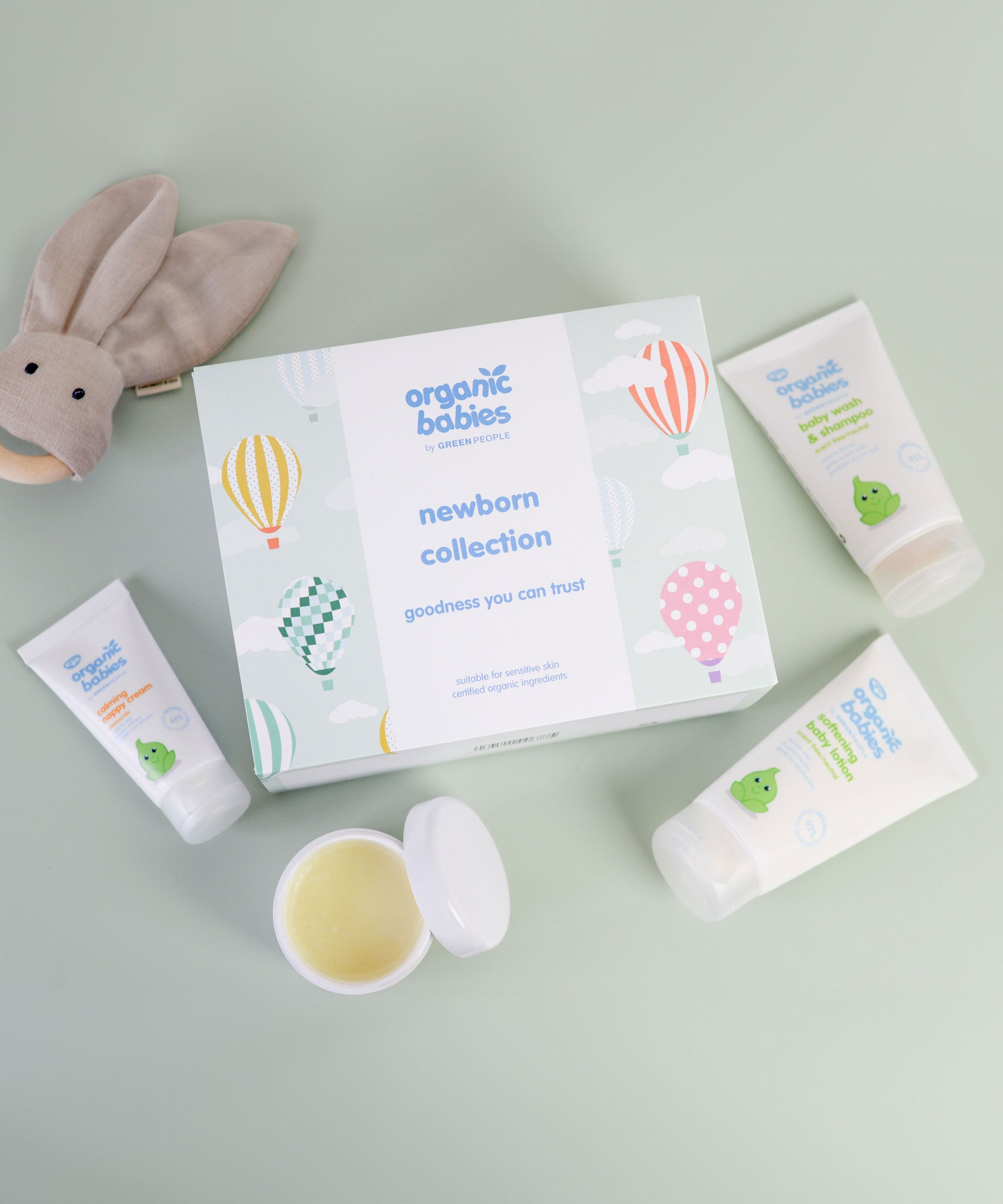 A flatlay of the Green People Organic Babies Newborn Gift Set Box with the products outside the box. 