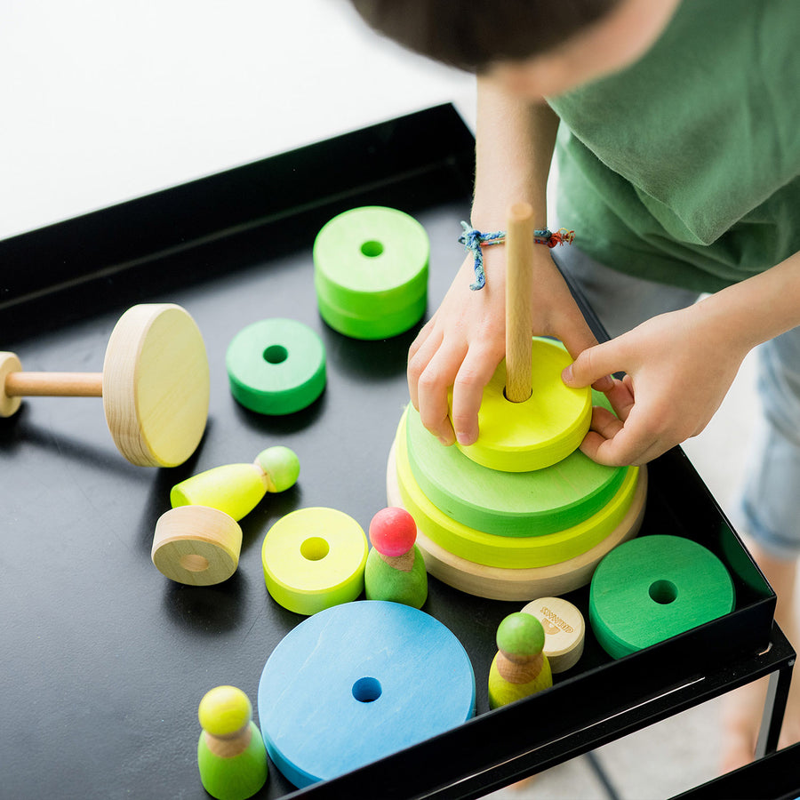 Grimm's Conical Stacking Tower - Neon Green - A child plays with Grimm's Rainbows