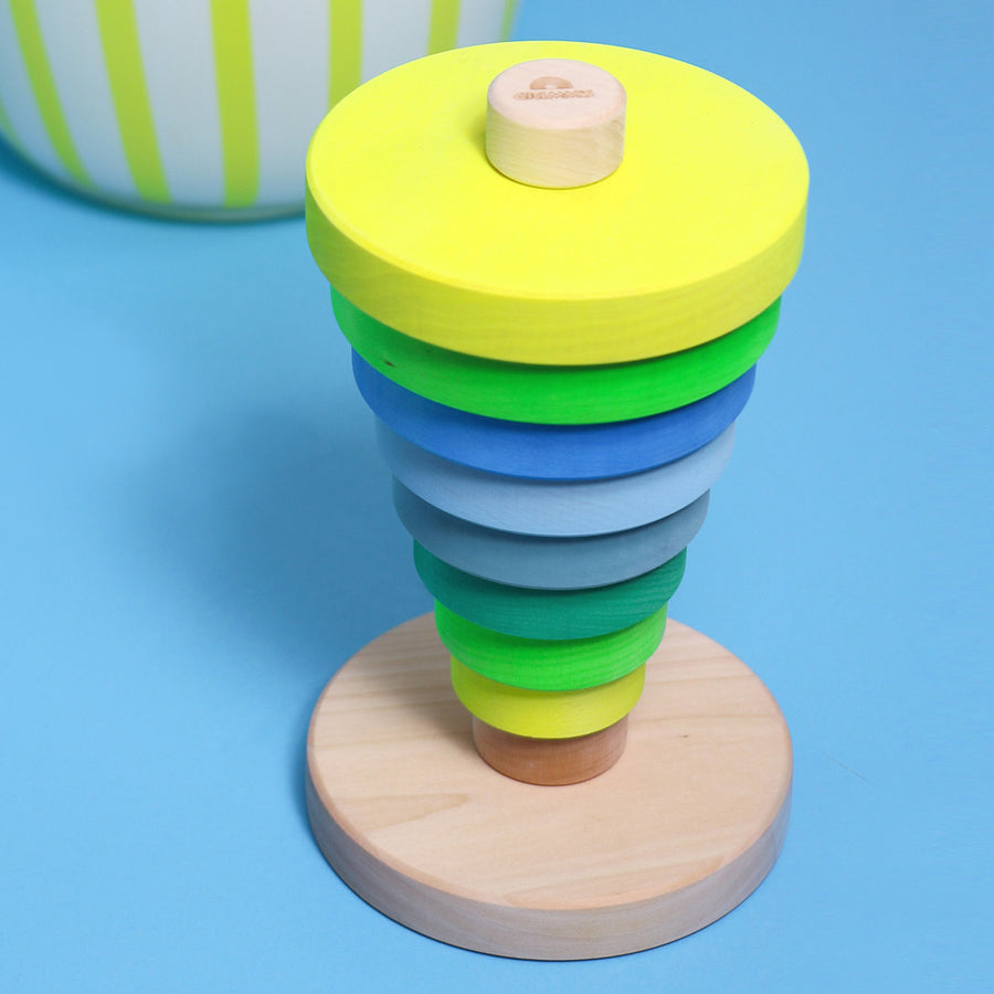 Grimm's Conical Stacking Tower - Neon Green - On a plain pink background. Alternative stacking layout.