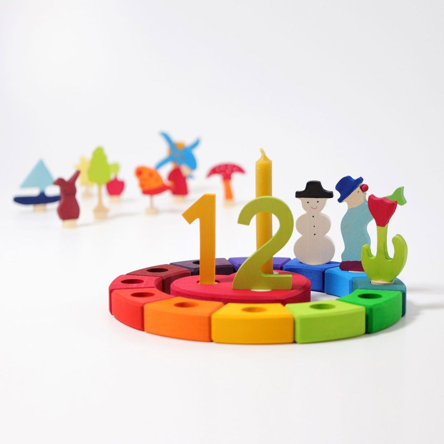 Grimm's 12-Piece Rainbow Birthday Celebration Ring with a celebration heart in the centre and decorative figures for an twelfth birthday