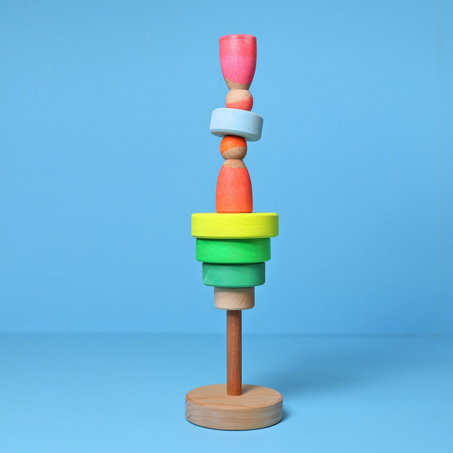 Grimm's Small Conical Stacking Tower - Neon Green - On a plain pink background. Alternative puzzle layout.