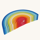 The Grimm's Gwawr Sunrise 12 Piece Rainbow on a plain background. The rainbow has been placed on it's side showing the Grimm's Babipur logo undeeneath on the red piece. 