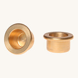 Grimm's brass candle holders to fit celebration rings on a plain background. 